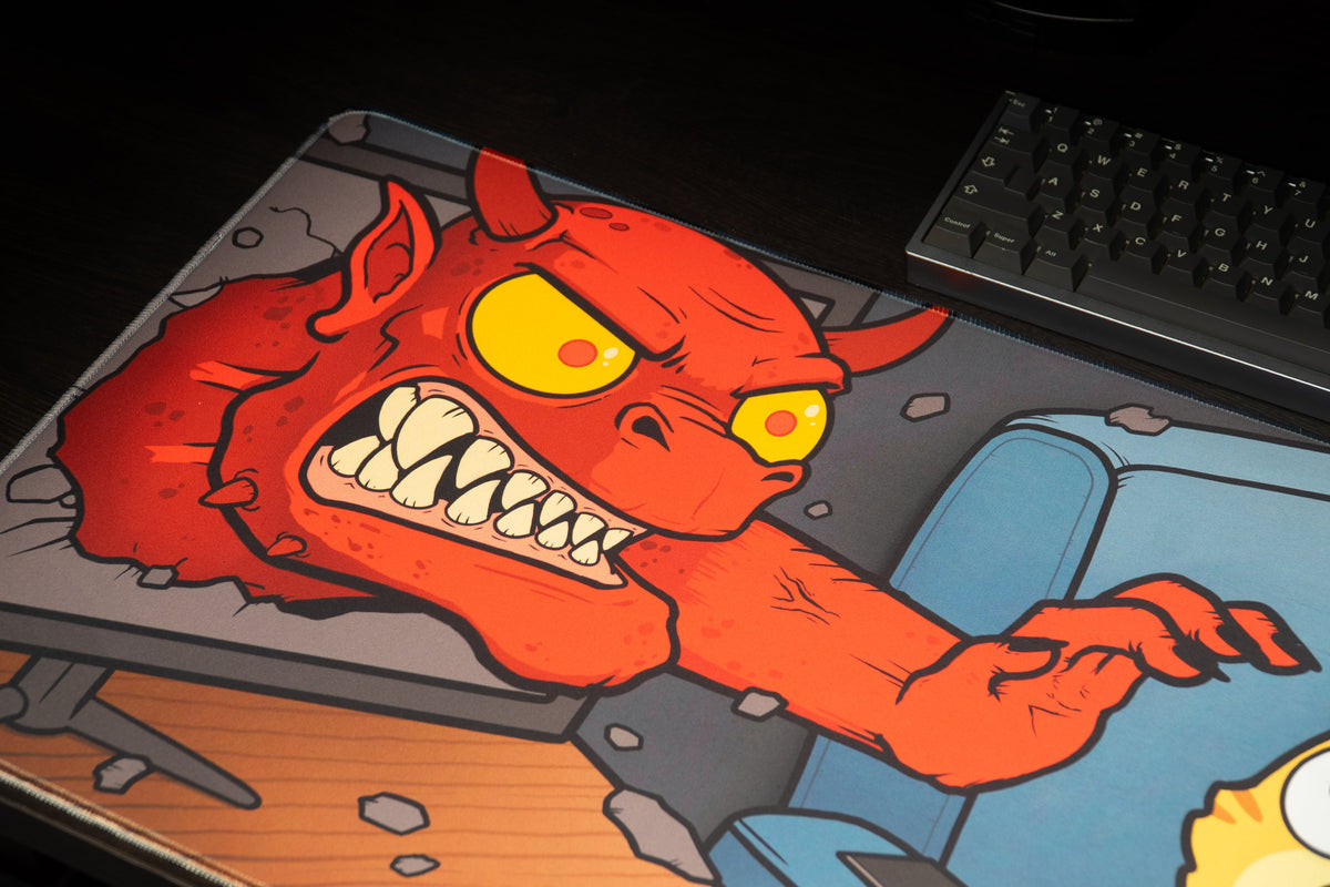 Close-up of the red demon bursting through a screen on the Dansgaming Horror Month 2026 gaming deskmat.