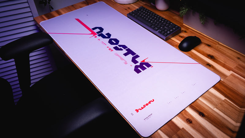 Large desk mat with 'GHOST' branding on a wooden desk