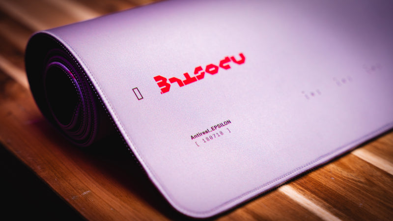 Gaming mouse pad with brand logo on a wooden surface