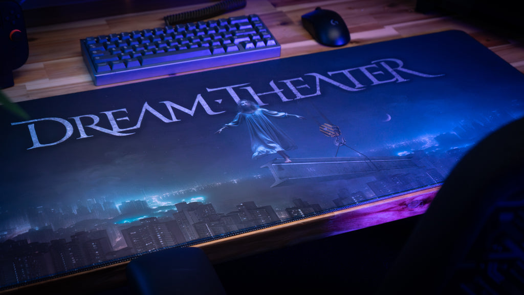 Large 'Dream Theater' branded mouse pad with keyboard and mouse on a desk