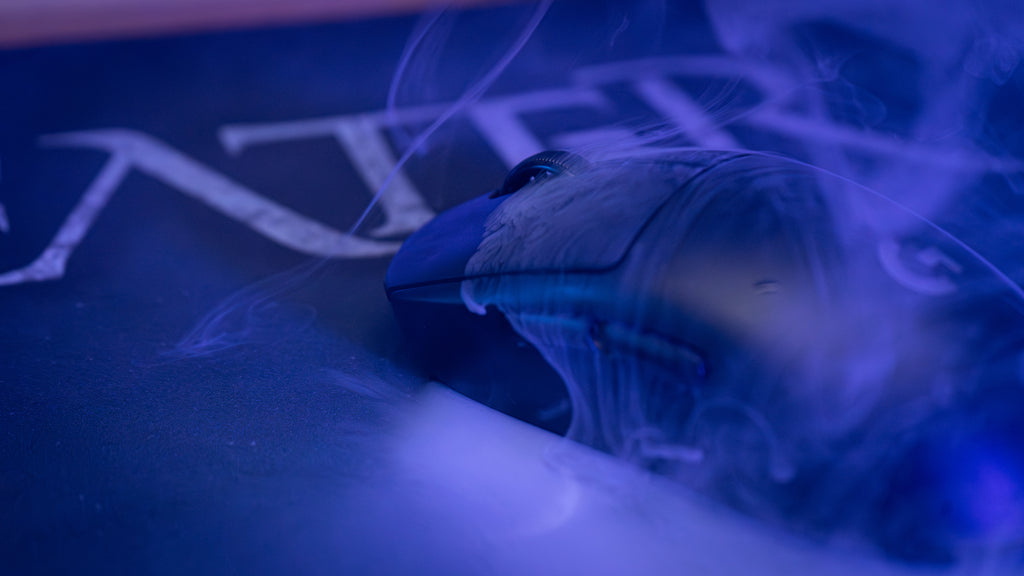 Close-up of a computer mouse with smoke effects on a dark background