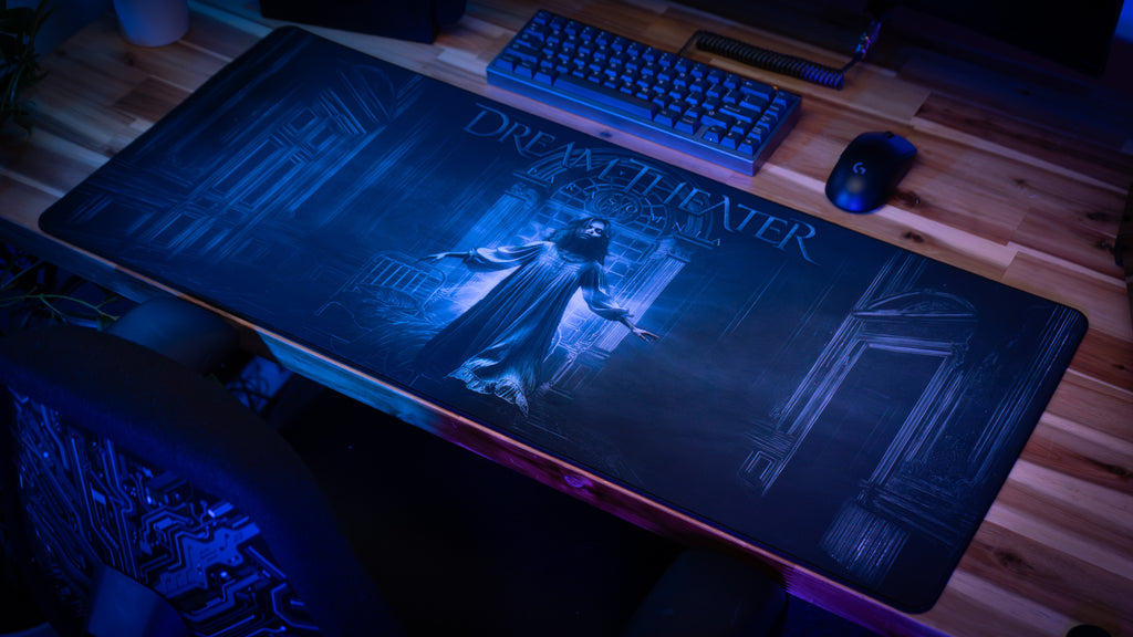Large gaming mouse pad with a dark design on a desk with a keyboard and mouse.