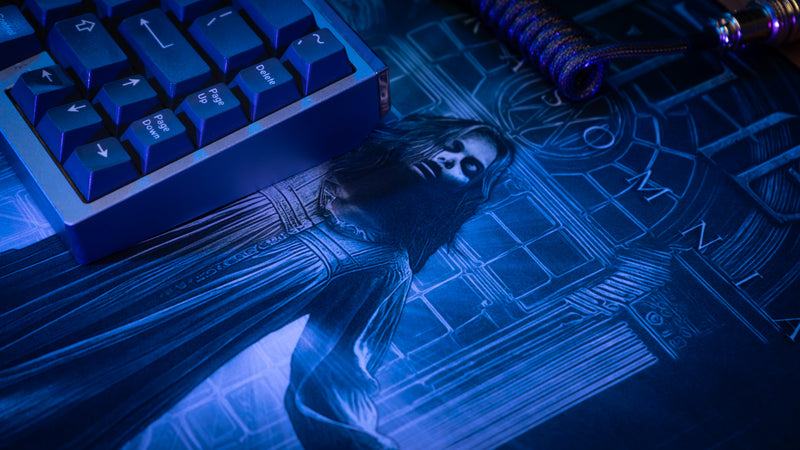 Blue-lit keyboard with a figurine on a mystical map