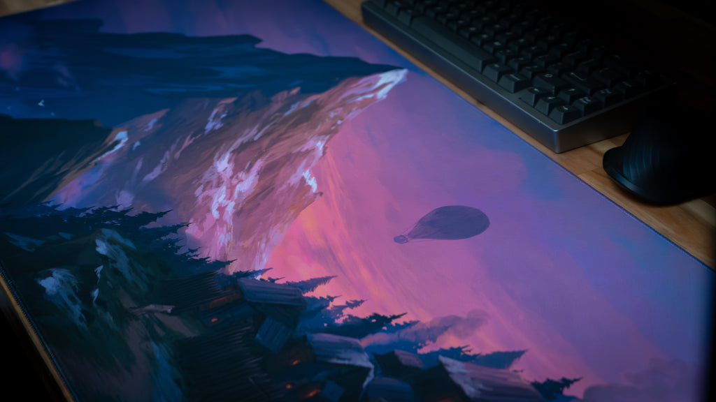 Desk mat with artistic design of mountains and hot air balloon on a desk