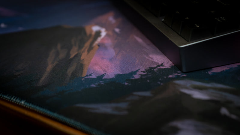 Laptop displaying a mountain landscape on a dark background