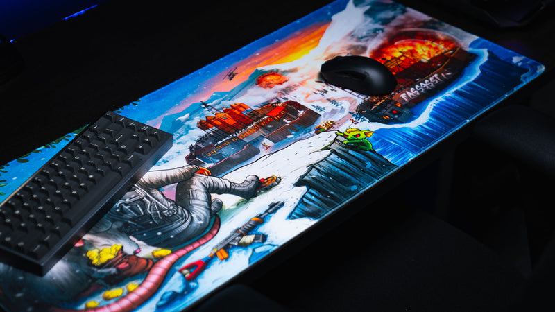 Angled view of the A Solo's Kingdom gaming deskmat by Gorliac featuring a snowy Rust landscape with bases, explosions, and a cliffside survivor.