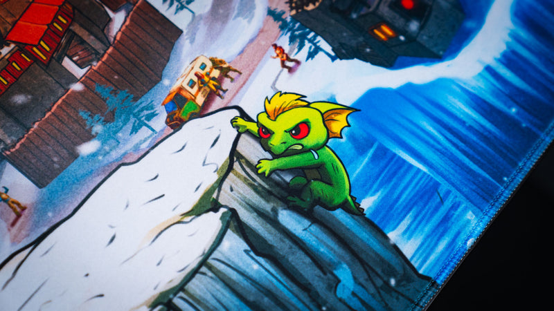 Close-up of the A Solo's Kingdom gaming deskmat by Gorliac featuring a green cliff creature overlooking a snowy Rust base and frozen coastline.