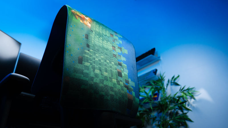 ApolloTV “Adventure Begins” deskmat displayed vertically with pixel-style forest artwork and stitched edges in a blue-lit gaming setup.