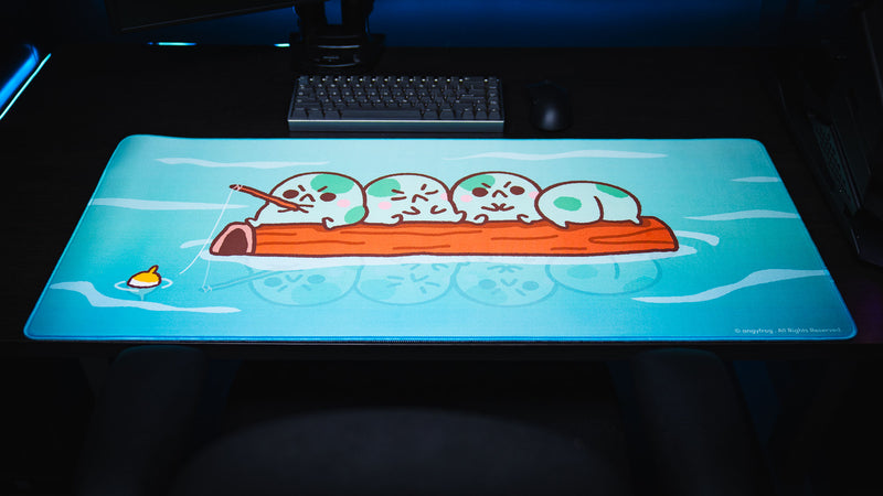 Front view of the Angyfrog Frogs on a Log desk mat centered beneath a keyboard and monitor