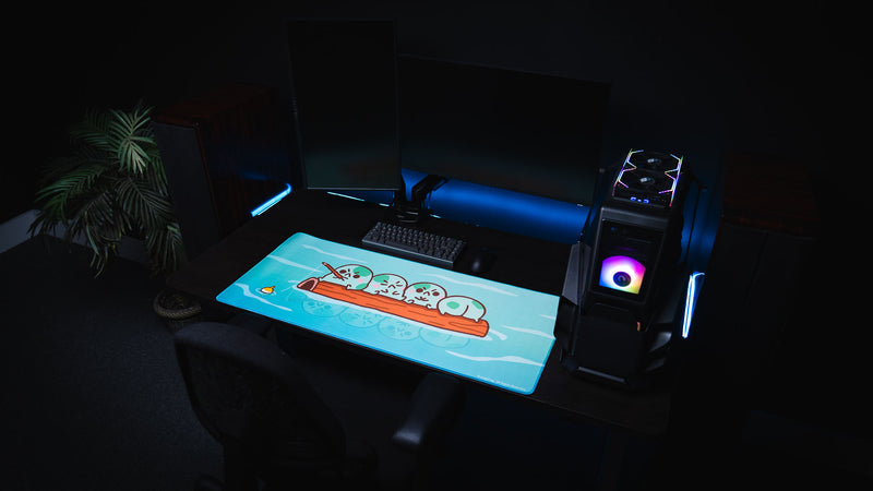 Wide RGB gaming setup featuring the turquoise Angyfrog Frogs on a Log desk mat and desktop PC