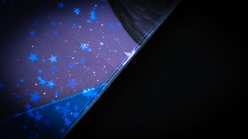 Close-up of the Bald Eagle Blue America 250 deskmat showing blue patriotic star artwork, premium fabric texture, and stitched edge detail.