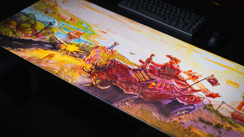 Angled view of the Rust After Glory desk mat showing the coastal battlefield and armored vehicle scene
