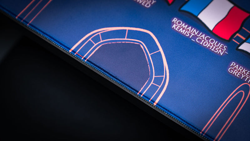 Close-up detail of the castle arch artwork and stitched edge on the Bingo Brawlers Season 6 Commemorative Deskmat.