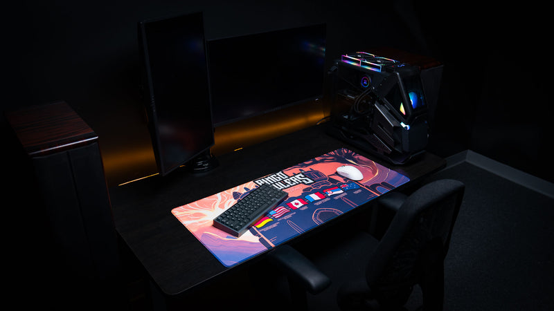 Bingo Brawlers Season 6 Commemorative Deskmat displayed in a complete gaming desk setup with keyboard, mouse, monitor, and custom PC.
