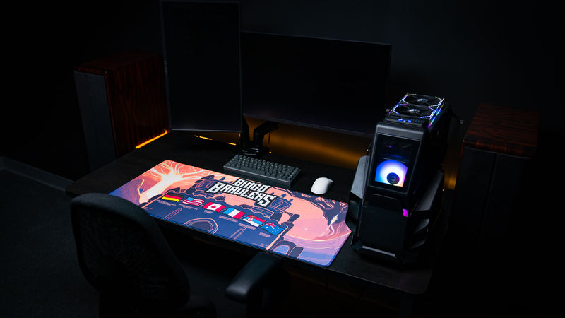 Bingo Brawlers Season 6 Commemorative Deskmat displayed in a complete gaming setup with keyboard, mouse, monitor, and PC.