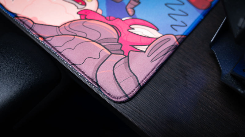 Close-up of the Bingus Bongus deskmat corner featuring premium stitched edges, smooth surface material, and detailed character artwork.