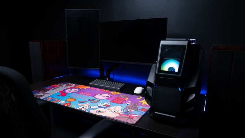 Full gaming desk setup featuring the Bingus Bongus deskmat with mechanical keyboard, wireless mouse, RGB desktop PC, and complete artwork on display.