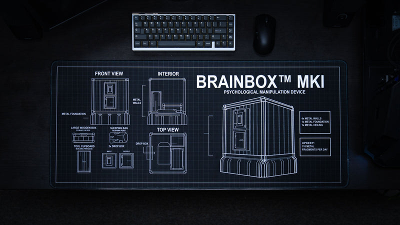 BRAINBOX™ MK1 deskmat by DackFive featuring a detailed Rust base blueprint schematic with technical diagrams, building layouts, and tactical design elements on a premium gaming deskmat.