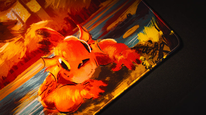 Close-up of the orange Bubbles creature artwork and stitched border on the Exodo Studios playmat