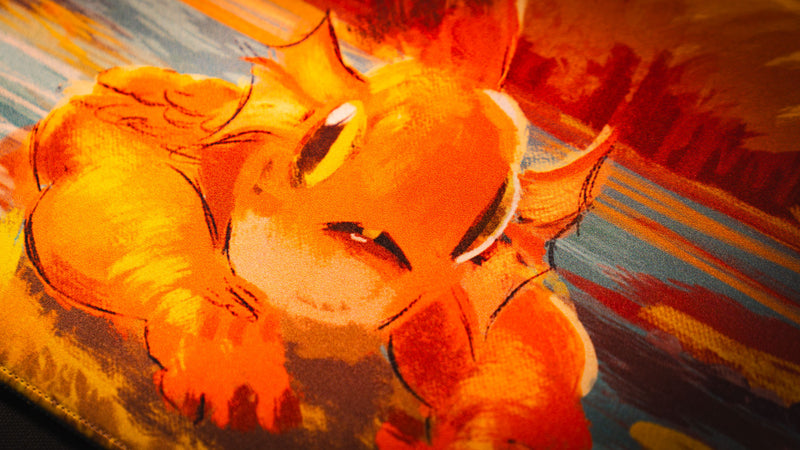 Detailed close-up of the orange Bubbles creature printed on the Exodo Studios playmat