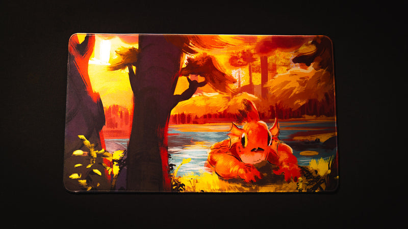 Top view of the Bubbles Playmat by Exodo Studios with vivid orange creature artwork on a black table