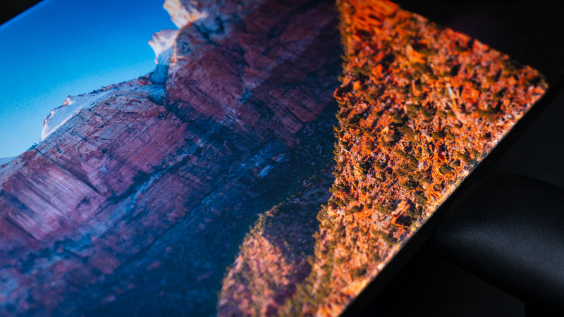 Close-up of the Canyon Junction deskmat showcasing Zion National Park's towering sandstone cliffs, vibrant HD photography, premium stitched edges, and a smooth gaming surface.