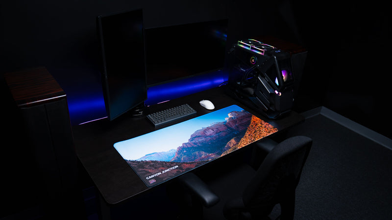 Canyon Junction deskmat displayed in a premium gaming workstation, featuring Zion National Park's dramatic canyon landscape, vibrant HD photography, and premium stitched edges.
