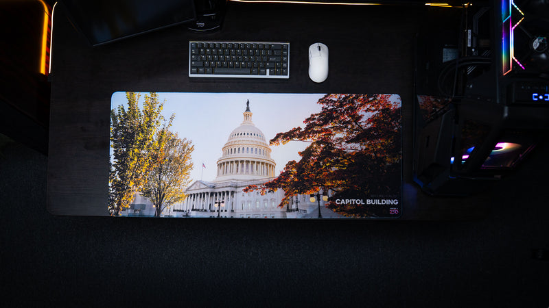 Top-down view of the Capitol Building deskmat featuring the U.S. Capitol framed by autumn trees on a premium extended mouse pad in a modern gaming and office setup.