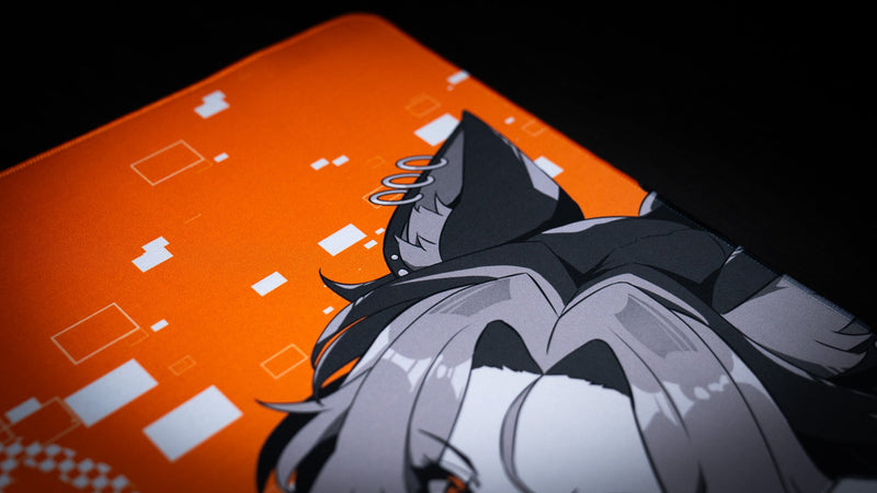 Close-up of the orange background and wolf ear artwork on the CelisEris Brand Risk gaming deskmat