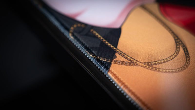 Close-up of the stitched edge on the CelisEris Martial gaming deskmat