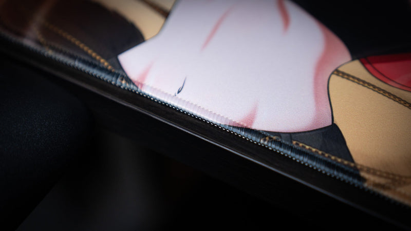 Close-up of the stitched edge and printed character artwork on the CelisEris Martial playmat