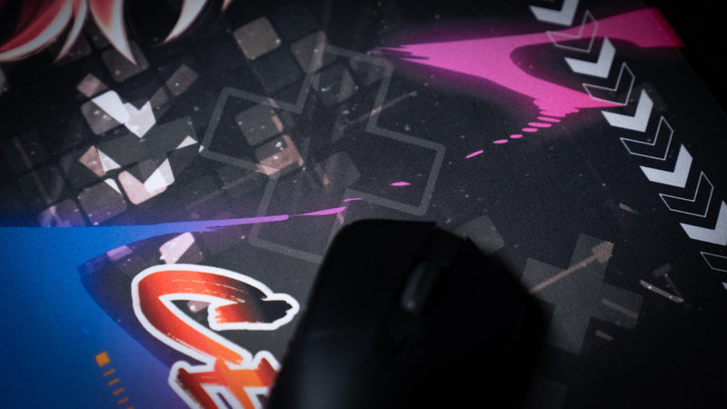 Close-up of a mouse on the blue and magenta CelisEris Spectral Wolf gaming deskmat