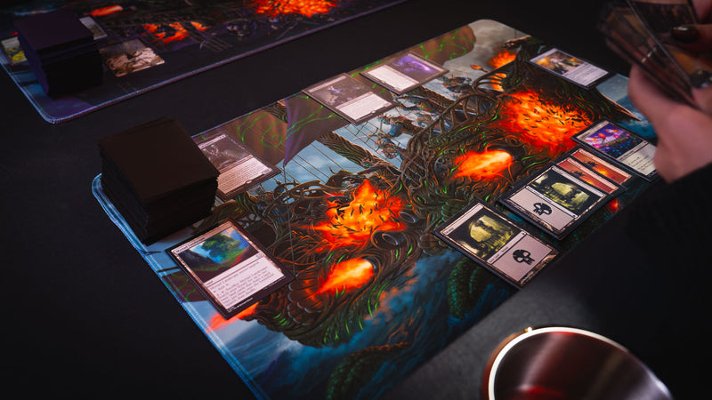Magic: The Gathering game in progress on the Coralborn playmat, highlighting the intricate fantasy ship artwork, vivid colors, stitched edges, and spacious premium surface for TCG gameplay.