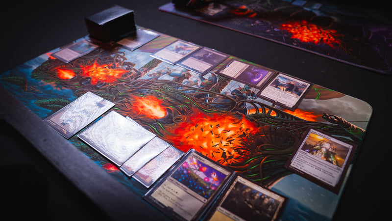 Magic: The Gathering cards arranged on the Coralborn playmat, highlighting the intricate fantasy warship artwork, vivid print quality, premium stitched edges, and spacious surface for immersive TCG gameplay.