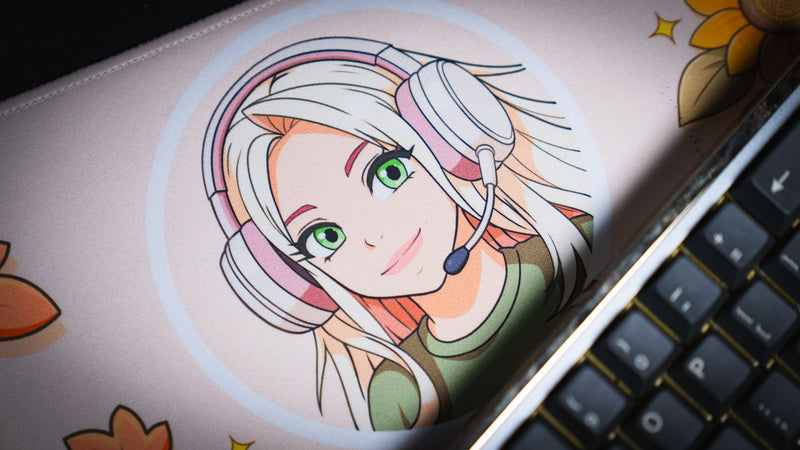 Close-up of the Cozy Desk deskmat featuring a pastel anime gamer avatar with a headset, surrounded by warm autumn-themed artwork and soft seasonal colors.