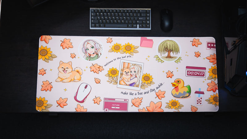 Cozy Desk deskmat with a warm autumn aesthetic featuring a smiling dog, pastel anime portrait, fall leaves, sunflowers, cozy desktop icons, and seasonal decorations