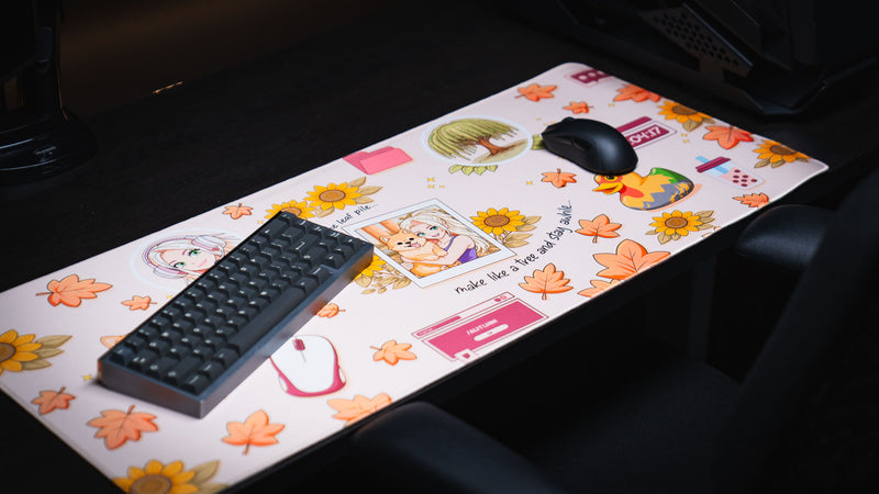 Cozy Desk deskmat displayed in a gaming setup featuring autumn leaves, sunflowers, a cute dog, cozy desktop icons, and a warm pastel aesthetic.