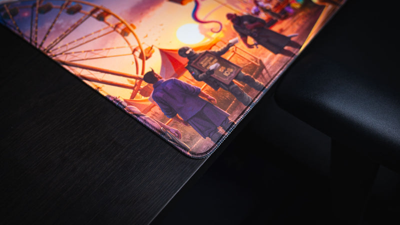 Stitched edge and Ferris wheel artwork on the Crowmedia Festival of Feathers gaming deskmat