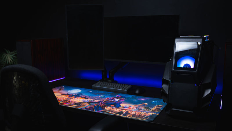 Front view of an RGB gaming PC setup featuring the Crowmedia Festival of Feathers deskmat