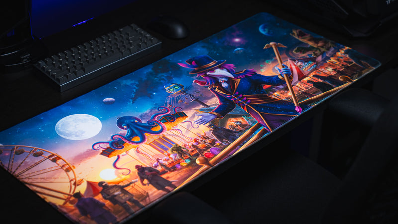 Wide angled gaming setup showing the full Crowmedia Festival of Feathers deskmat artwork