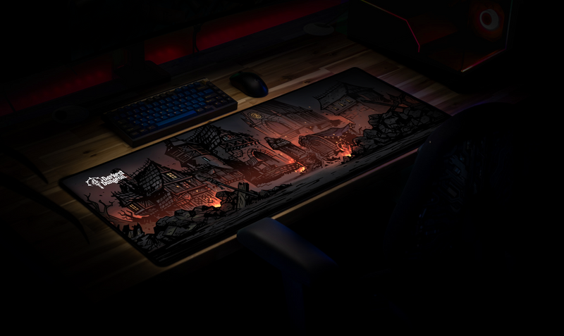 Darkest Dungeon Design 2 desk mat in a dim gaming setup, viewed at an angle beside a keyboard and mouse