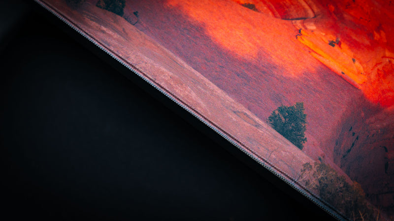 Close-up of the Death Bowl deskmat highlighting the premium stitched edge, detailed desert terrain, and vibrant red sandstone landscape from Arches National Park.