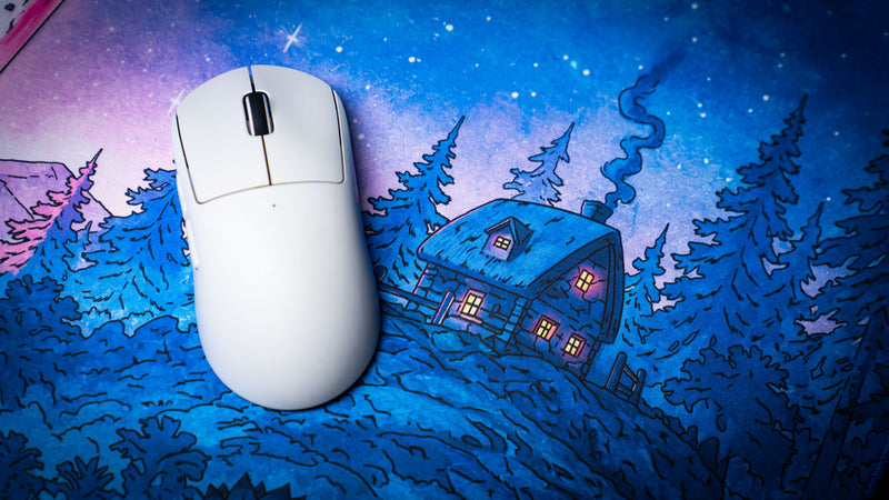 Close-up of the Dino Abduction Rust deskmat highlighting the illustrated forest cabin and detailed artwork beneath a white gaming mouse.