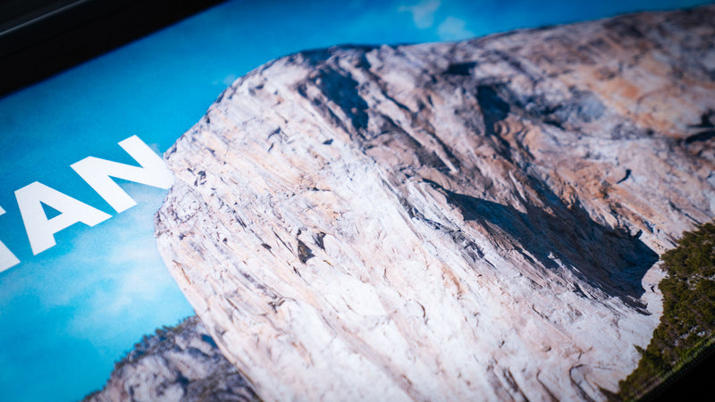 Close-up of the El Capitan deskmat showcasing Yosemite National Park's iconic granite cliff with vibrant HD print, premium stitched edges, and a smooth gaming surface.