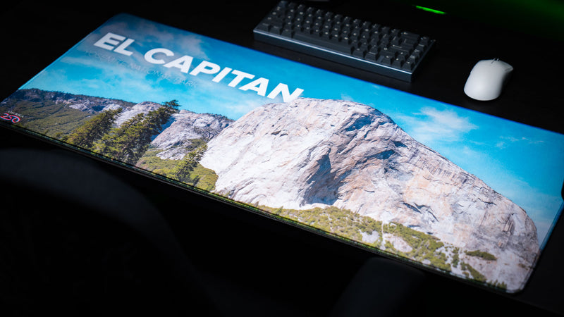 El Capitan deskmat featuring Yosemite National Park's iconic granite monolith in a panoramic landscape with vibrant HD photography, premium stitched edges, and a smooth gaming surface.