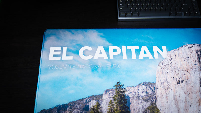 Close-up of the El Capitan deskmat highlighting Yosemite National Park branding, bold typography, crisp HD print quality, and premium stitched edges.