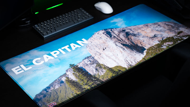 El Capitan deskmat showcasing Yosemite National Park's iconic granite monolith in a panoramic gaming setup with vibrant HD photography and premium stitched edges.