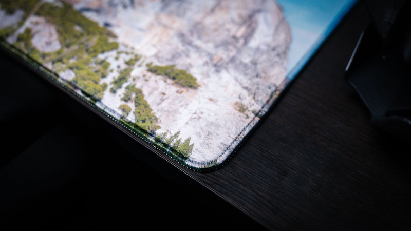Close-up of the El Capitan deskmat highlighting premium stitched edges, detailed Yosemite National Park photography, durable construction, and a smooth gaming surface.