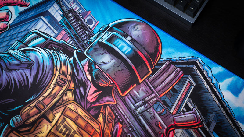 Close-up of the Extraction Boss deskmat by ImOw, highlighting the tactical operator's ballistic helmet, rifle, and detailed comic-style artwork with vivid colors on a premium stitched-edge gaming deskmat.
