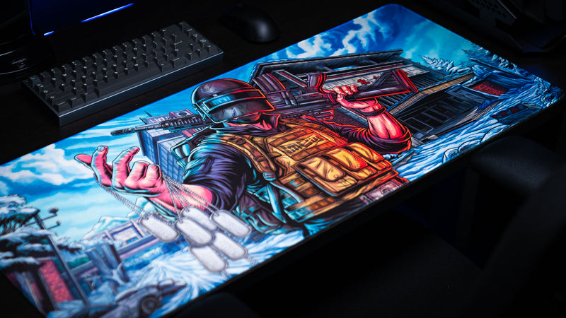Angled view of the Extraction Boss deskmat by ImOw featuring a detailed comic-style soldier illustration, snowy environment, and premium stitched-edge gaming surface.